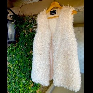 White faux fur vest.